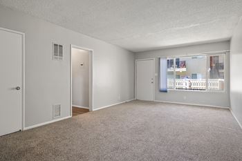 an empty bedroom with a large window